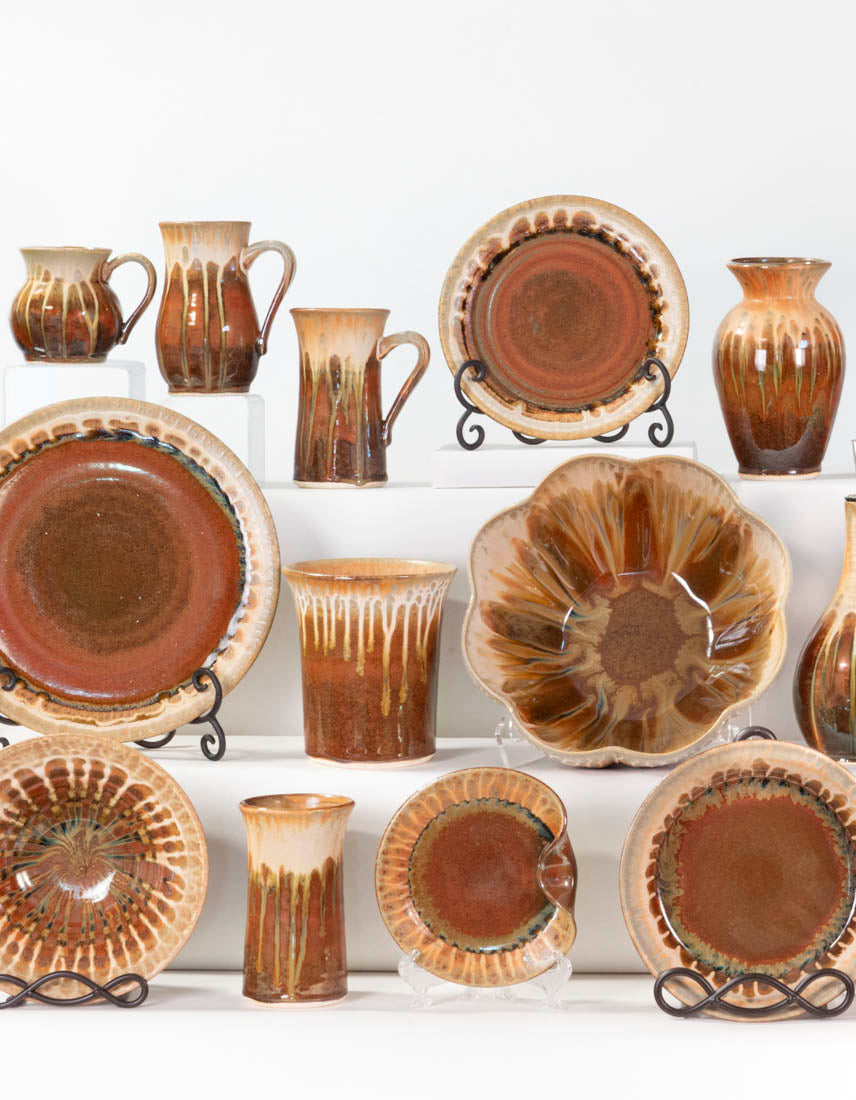 Display of handmade pottery dinnerware & home accessories in Golden Amber Glaze