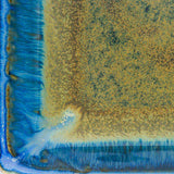 7 inch square ceramic plate close up in amber blue glaze