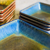 handmade pottery plates close up in amber blue glaze and square design